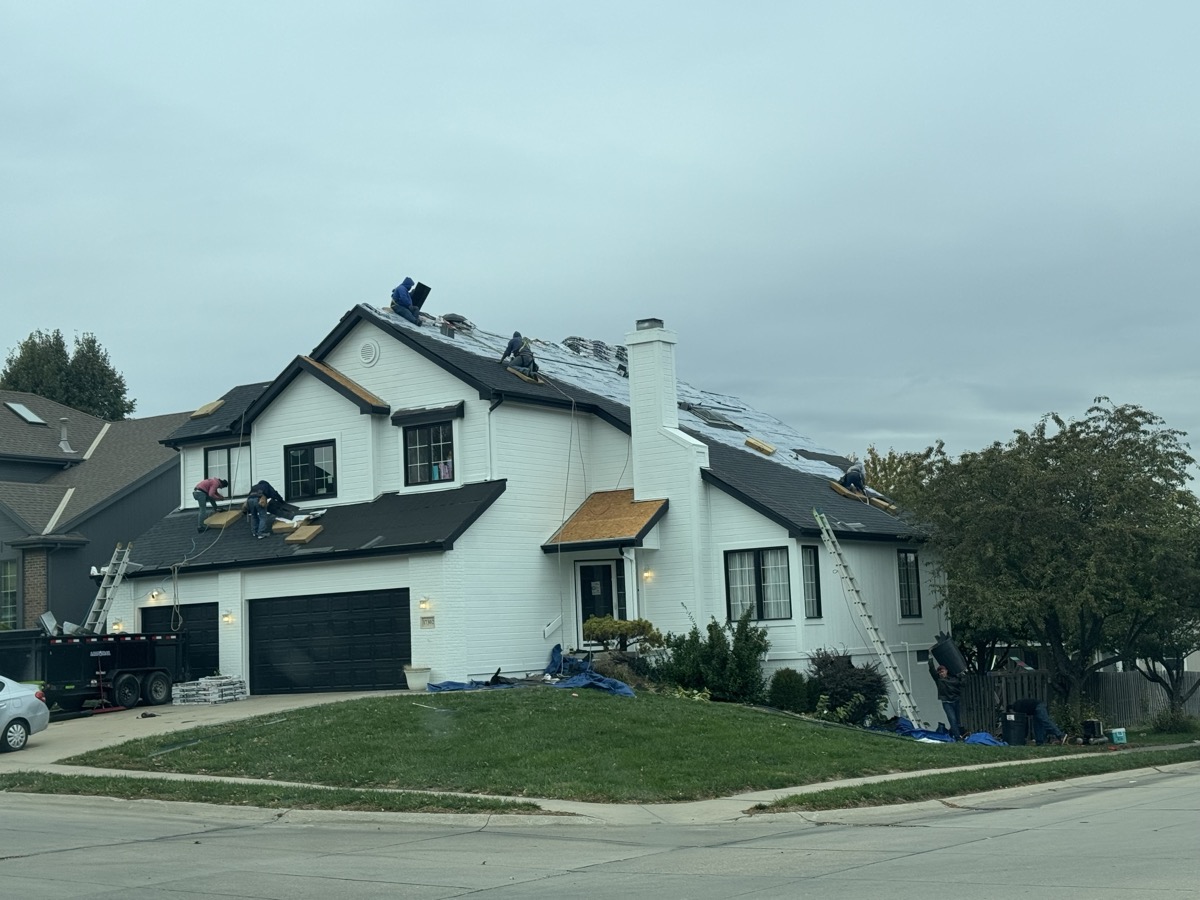 Expert roofing services deliver lasting protection for your home. An overhead view of a completed asphalt shingle roof with clean ridge lines and proper flashing. width=